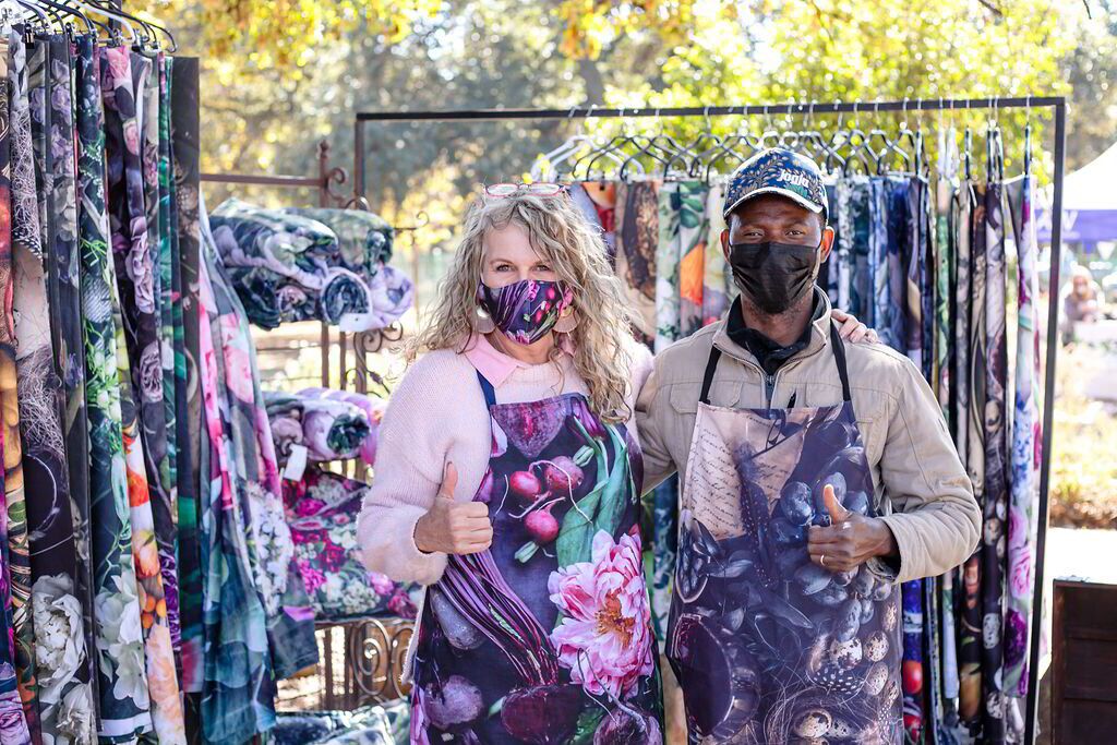 Man and woman selling clothes at The Linden Market. Pet-friendly things to do in Johannesburg.