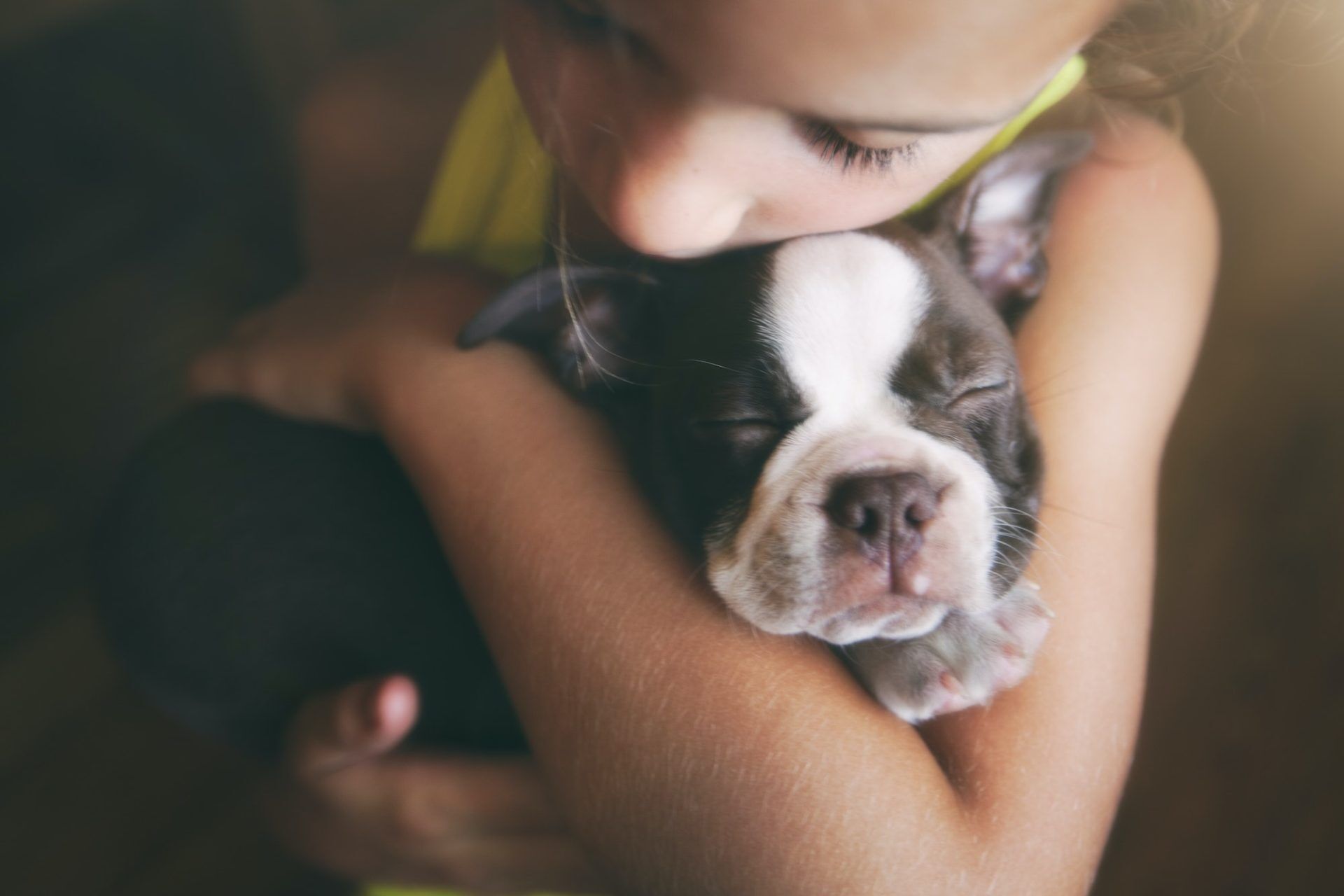 Girl hugging puppy